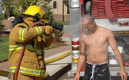 COLORADO SPRINGS, Colo. - A Colorado Springs Fire Department firefighter sprays down Colorado Springs Police Officer Eric Price following a simulated chemical attack during the Coalition Warrior Interoperability Demonstration June 16. The exercise simulated a terrorist bomb attack that destroyed several communications towers and released a plume of chlorine gas that sickened several first responders. (U.S. Air Force photo by Staff Sgt. Thomas J. Doscher)