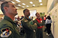 HOUMA, La. – (left to right) Col. Jeff Fiebig, the mobilization assistant to the commander, First Air Force, Tyndall AFB, Fla., Maj. Gen. Garry Dean, the joint force air component commander for North American Aerospace Defense Command and U.S. Northern Command, and Cmdr. Drew Cromwell, air operations branch chief for the Houma Incident Command Post, analyze safety information in the operations center in the central operations room, June 15, 2010. Dean visited the command post to discuss ways the Air Force can assist in the Gulf for the nation’s largest oil spill response and recovery.  U.S. Coast Guard photo by Petty Officer 3rd Class Robert Brazzell.