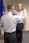 Air Force Brig. Gen. Robert C. Nolan II, Joint Task Force National Scout Jamboree commander is sworn in July 14 by the Virginia Adjutant General in Richmond, Va. Nolan is the first Title 10 active-duty officer to be given command of both federal forces and National Guard troops. 

