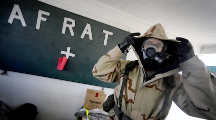 U.S. Air Force Staff Sgt. Kevin Rivera, of the Air Force Radiation Assessment Team (AFRAT) from the United States Air Force School of Aerospace Medicine at Brooks City Base, Texas, puts on his joint service lightweight integrated suit technology during exercise Vibrant Response 10.2 July 15, 2010, in Jennings, Ind. Vibrant Response 10.2 is a U.S. Northern Command training event for the chemical, biological, radiological, nuclear and high yield explosives consequence management response force 10.2.  (U.S. Air Force photo by Staff Sgt. Angelita M. Lawrence/Released)
