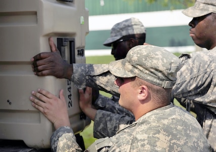 U.S. Soldiers from Headquarters and Headquarters Company, 4th Battalion, 118th Infantry Regiment pack gear to move to Forward Operating Base Panther, a simulated base, July 15, 2010, during exercise Vibrant Response 10.2 at Camp Atterbury, Ind. Vibrant Response 10.2 is a U.S. Northern Command training event for the chemical, biological, radiological, nuclear and high yield explosives consequence management response force 10.2. (U.S. Air Force photo by Airman 1st Class Samuel W. Goodman/Released)