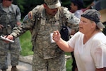 A U.S. Soldier with Alpha Company, 4th Battalion, 118th Infantry Regiment cares for a simulated wounded civilian July 15, 2010, at Camp Atterbury, Ind., as part of Vibrant Response 10.2. Vibrant Response, a U.S. Northern Command exercise for Chemical, Biological, Radiological, Nuclear and High-Yield Explosive Consequence Management Response Force 10.2, focuses on Department of Defense support of civil authorities in a consequence management role. (U.S. Air Force photo by Airman 1st Class Samuel W. Goodman/Released) 