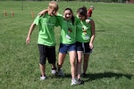 From left to right: Lane Schmidt, of Sullivan, Morgan Brooks, of O'Fallon and Ashley Anderson, of Columbia, race for first place in the four-legged relay during a youth camp held by the Missouri National Guard.