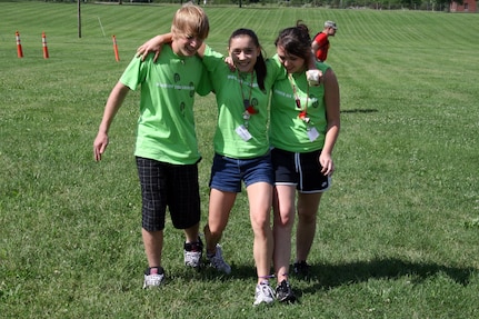 From left to right: Lane Schmidt, of Sullivan, Morgan Brooks, of O'Fallon and Ashley Anderson, of Columbia, race for first place in the four-legged relay during a youth camp held by the Missouri National Guard.