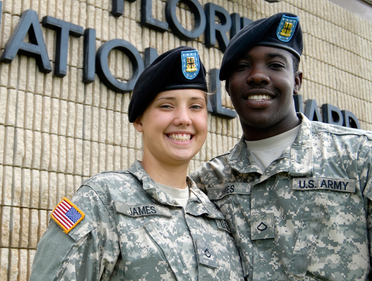 Pfcs. Samantha and Joseph James of the 1218th Transportation Company pose for a photo outside of the unit's armory in West Palm Beach, Fla., July 1, 2009. The James' are one of the three married couples - all truck drivers - who are deploying with the unit in support of Operation Iraqi Freedom.