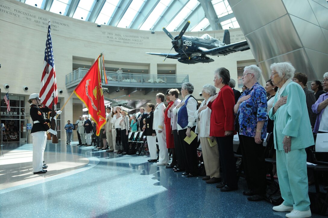 A group of retired female Marines faces a female color guard during the playing of the national anthem at the National Museum of the Marine Corps’ dedication of its Molly Marine statue July 5, 2013. 