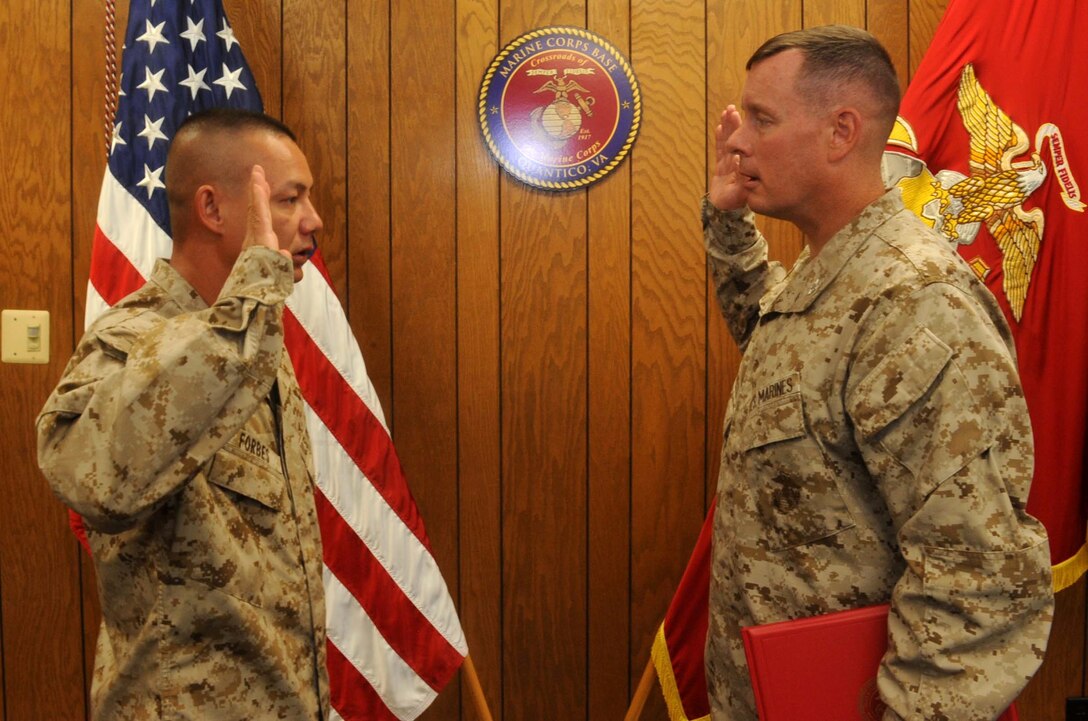 Col. David Maxwell conducts Master Sgt. Anthony Forbes’s re-enlistment ceremony July 3, 2013, on Marine Corps Base Quantico. First-term Forbes has been serving as a Marine for almost 25 years. 