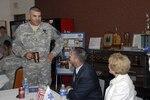 Army Maj. Gen. Hugo E. Salazar, the adjutant general and commanding general of the Arizona National Guard, standing left, discusses the aspects of the Arizona Coalition for Military Families with Arizona state senator Jack Harper, center, and TriWest Healthcare Alliance Community Relations Director Anne Wendell, right, during the inaugural meeting held in Phoenix, on Aug. 19, 2009.