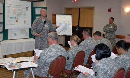 Master Sgt. Jody Courts briefs the support staff for a reintegration event for members of the 34th Infantry Division held in Bloomington, Minn., September 2007. Over 1,000 Soldiers and family members there attended a 30-Day Reintegration event, which reconnects Soldiers and families with service providers through workshops and round-robin stations. The Minnesota National Guard is credited with starting the Yellow Ribbon Program.