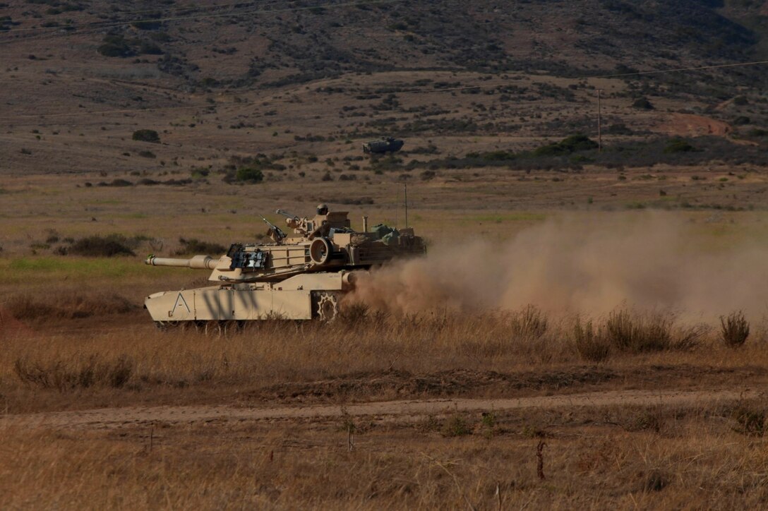 Marines with Tank Detachment, Battalion Landing Team 1/4, 13th Marine Expeditionary Unit maneuver their M1A1 Abrams Tank into a defensive posture at an assembly area after a training raid during PHIBRON-MEU Integration aboard Marine Corps Base Camp Pendleton, Calif., June 26, 2013. PMINT is a three week long pre-deployment training event focusing on the combined Marine Expeditionary Unit and Amphibious Ready Group capabilities and the strengthening of the Navy and Marine Corps team. (Official U.S. Marine Corps photo by Sgt. Christopher O’Quin/Released)