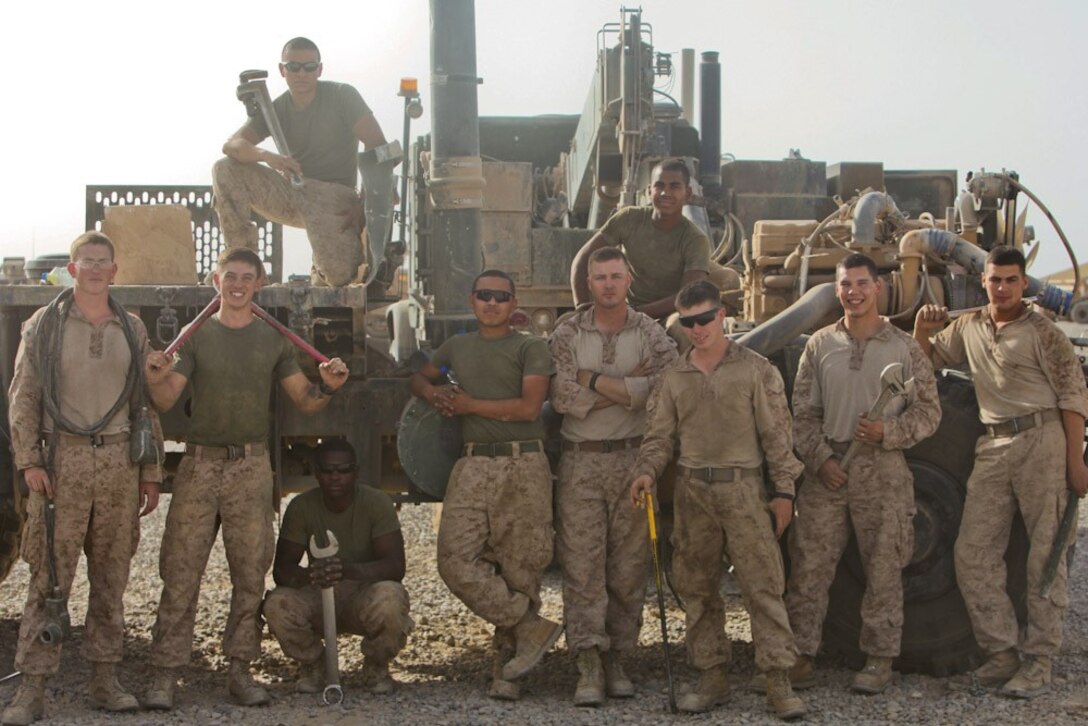 Motor transportation mechanics with 2nd Battalion, 8th Marine Regiment, Regimental Combat Team 7, pose for a section photo here, June 15, 2013. "These guys are my family," said Lance Cpl. Bladmir Burtica, 21, a motor transportation mechanic with 2nd Bn., 8th Marine Regiment and native of Poughkeepsie, N.Y. "Some days may be worse than others, but there's never a dull moment with them."