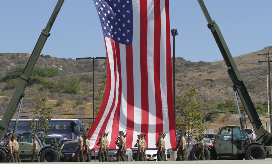 Marines serving with 1st Battalion, 5th Marine Regiment, march onto the Camp San Mateo parade deck, during a change of command ceremony here, June 28, 2013. Lt. Col. Keven Matthews, the incoming commanding officer of 1st Bn., 5th Marines, assumed command of the battalion from Lt. Col. Terry Johnson, the outgoing commanding officer of the battalion. Johnson led his Marines on a deployment to the Pacific as a part of the 31st Marine Expeditionary Unit.