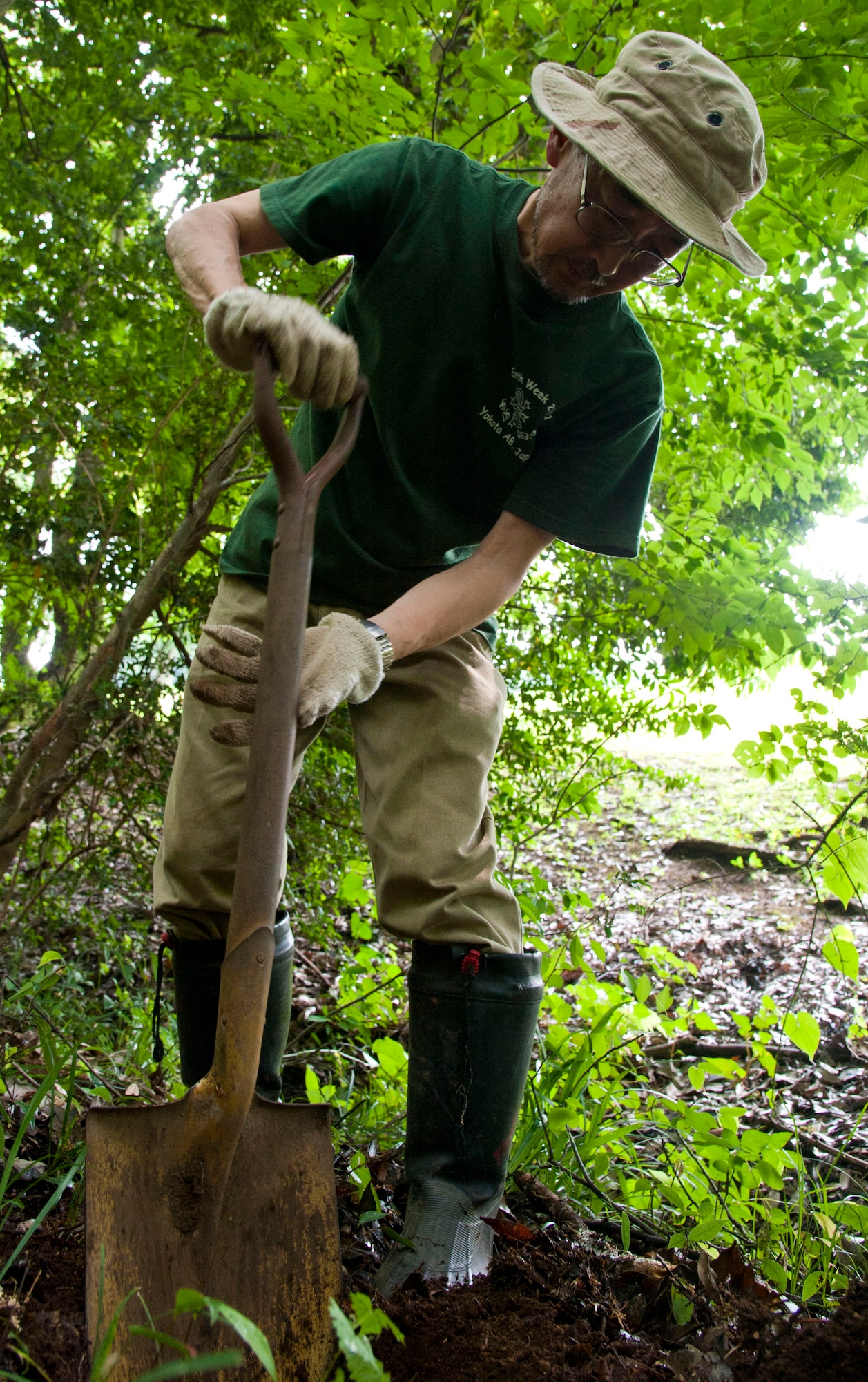 TAMA, Japan – Yoshitaka Yamaguchi, an environmental engineer with the 374th Civil Engineer Squadron, uses a shovel to transplant Golden Orchids at the Tama Hills recreation area, Japan, June 17, 2013.  Yamaguchi surveyed the area to find the perfect home for the rare Golden Orchids, which had to be relocated from Fussa City in order to preserve them.  (U.S. Air Force photo by Airman 1st Class Soo C. Kim)