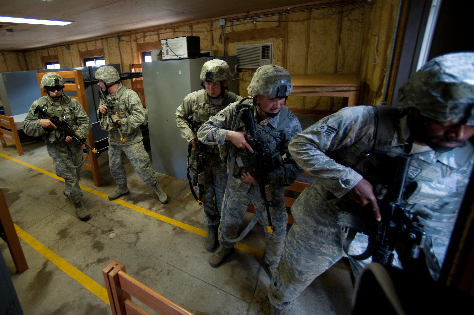 KUNSAN AIR BASE, Republic of Korea --Members of the 8th Security Forces Squadron prepare to exit a room after clearing it during a interior movements exercise at Wolf Pack Park at Kunsan Air Base, ROK June 27, 2013. The event was part of a three-day 8th SFS Combat Readiness Training exercise, which is unique to Korea and had a one-of-kind curriculum. (U.S. Air Force photo by Staff Sgt. Tong Duong)