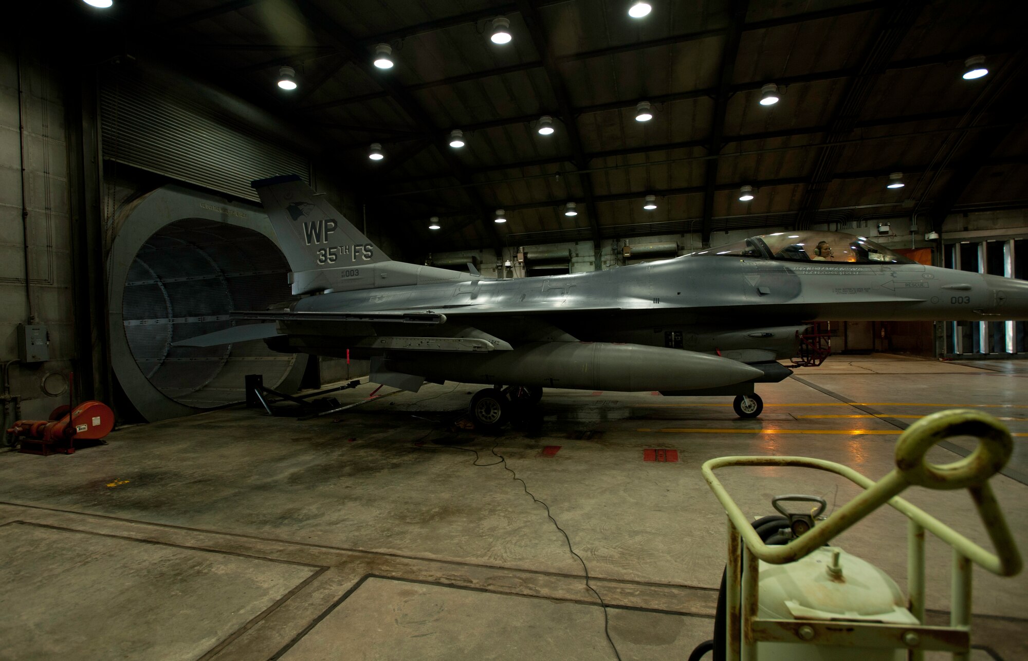 Staff Sgt. Sarah Belew, 35th Aircraft Maintenance Unit aerospace propulsion craftsman, relays information during an F-16 Fighting Falcon engine test at Kunsan Air Base, Republic of Korea, July 3, 2013. Belew tested a recently maintained engine to ensure a safe and reliable aircraft for the 35th Fighter Squadron pilots. (U.S. Air Force photo by Senior Airman Armando A. Schwier-Morales)   