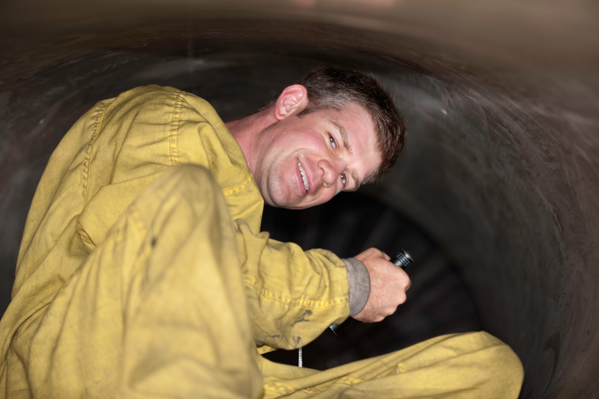 Tech. Sgt. Brian Pellettiere, 35th Aircraft Maintenance Unit electrical and environmental systems, crawls out of an intake vent after conducting an initial inspection at Kunsan Air Base, Republic of Korea, July 3, 2013. Pellettiere and several others from the 35th AMU tested an F-16 Fighting Falcon in order to assure a mission-ready aircraft. (U.S. Air Force photo by Senior Airman Armando A. Schwier-Morales)   