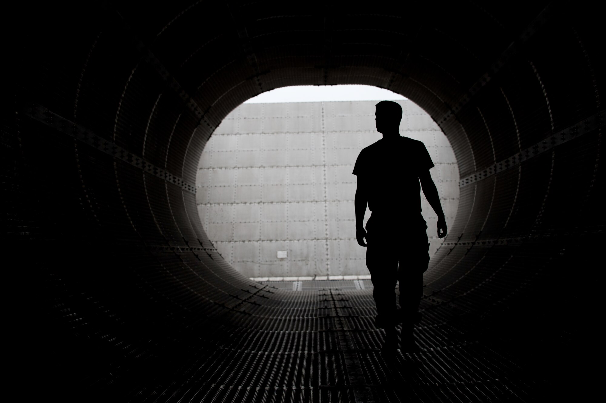 Senior Airman Corey Hicks, 8th Maintenance Squadron aerospace propulsion troop, inspects the Hush House tunnel for foreign object debris and loose screws at Kunsan Air Base, Republic of Korea, July 3, 2013. Maintainers use the Hush House to reduce the noise pollution and overall environmental effect of testing engines at full throttle. (U.S. Air Force photo by Senior Airman Armando A. Schwier-Morales)   