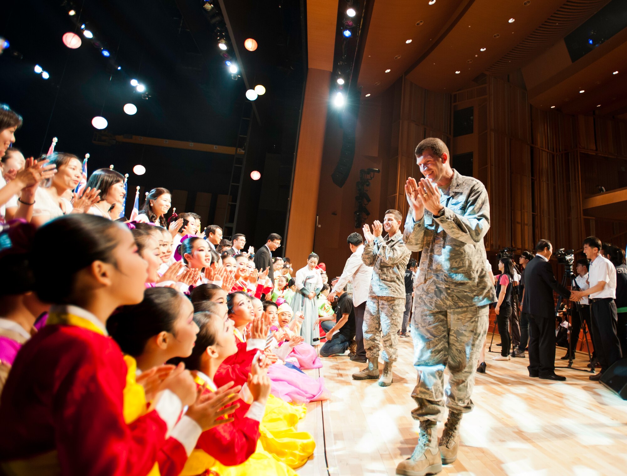 Col. S. Clinton Hinote, 8th Fighter Wing commander, front, and Col. Michael Morreale, 8th Maintenance Group commander, show their appreciation to performers during an appreciation concert at Gunsan City, South Korea, July 2, 2013. Traditional Korean dance and music, mixed with modern performances, were showcased as part of a ceremony to recognize the contributions made by United Nation Allies and Korean War veterans. (U.S. Air Force photo by Senior Airman Armando A. Schwier-Morales)   