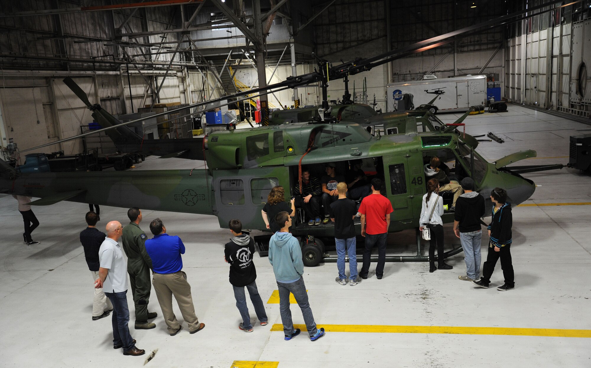 Spokane Community College aviation students receive a viewing of a UH-1N Huey helicopter static display during a base tour at Fairchild Air Force Base, Wash., June 26, 2013. The static display was hosted by Staff Sgt. Nicholas Poe, a flight engineer with the 36th Rescue Flight. (U.S. Air Force photo by Airman 1st Class Janelle Patiño/Released)