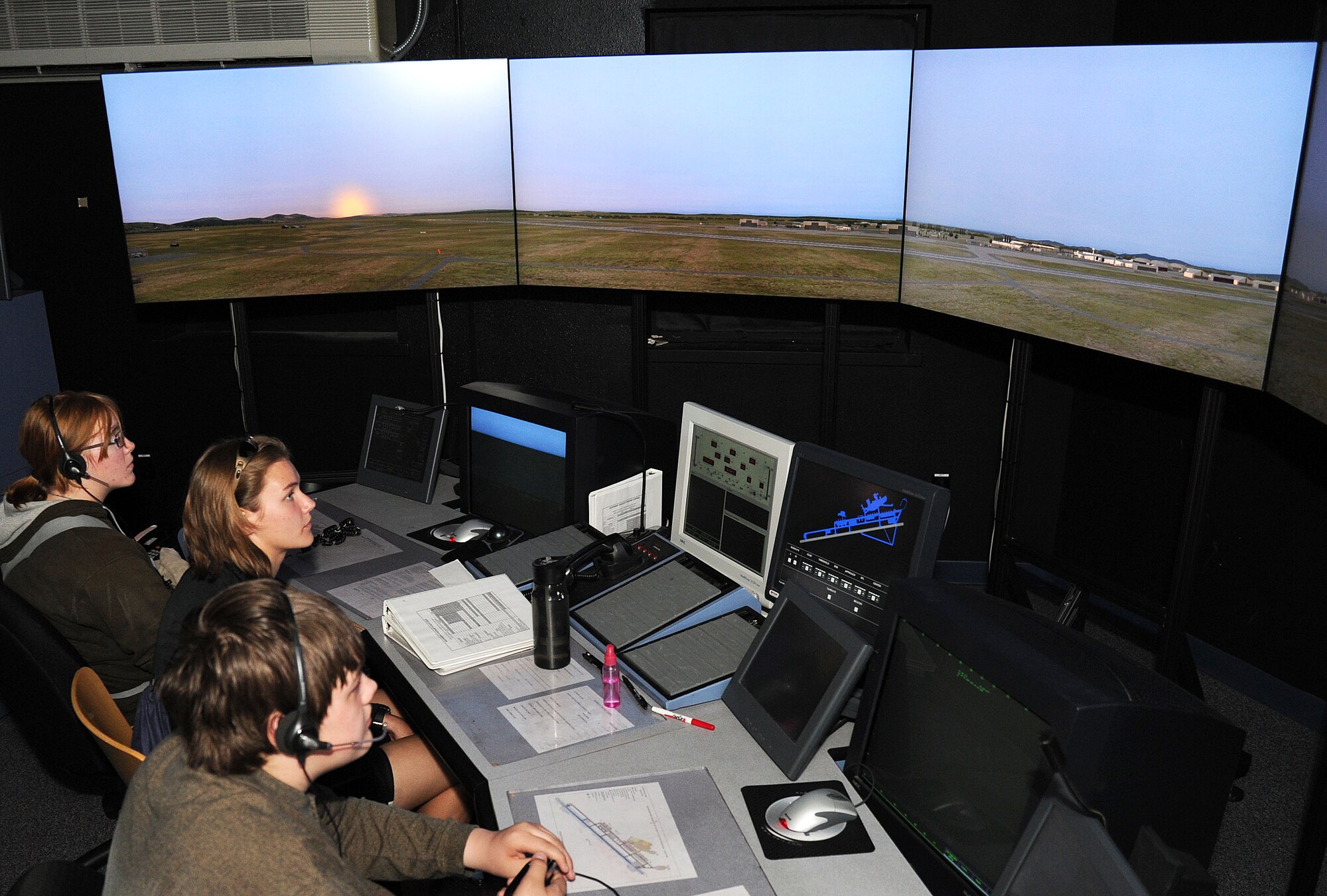Spokane Community College aviation students simulate working in the air traffic control simulator during a base tour at Fairchild Air Force Base, Wash., June 26, 2013. Fairchild hosted a tour which consisted of 20 aviation students from Spokane Community College. (U.S. Air Force photo by Airman 1st Class Janelle Patiño/Released)