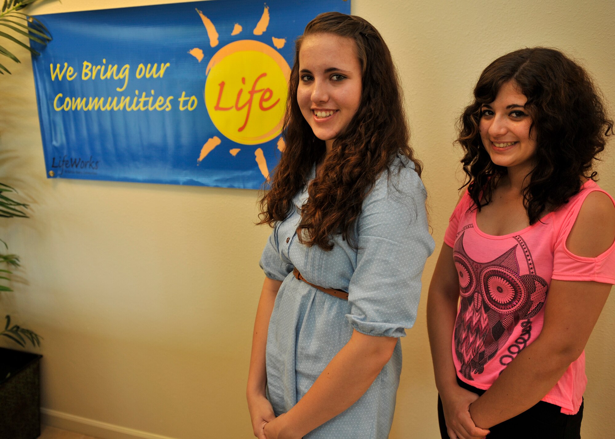 Katelyn and Andrea Felice, daughters of Lt.Col. Michael Felice, former 92nd Maintenance Squadron commander, pose for a photo at the Balfour Beatty community center at Fairchild Air Force Base, Wash., July 3, 2012. Andrea and Katelyn were recently awarded an academic scholarship from the Balfour Beatty Communities Foundation. (U.S. Air Force photo by Staff Sgt. Michael Means/Released)
