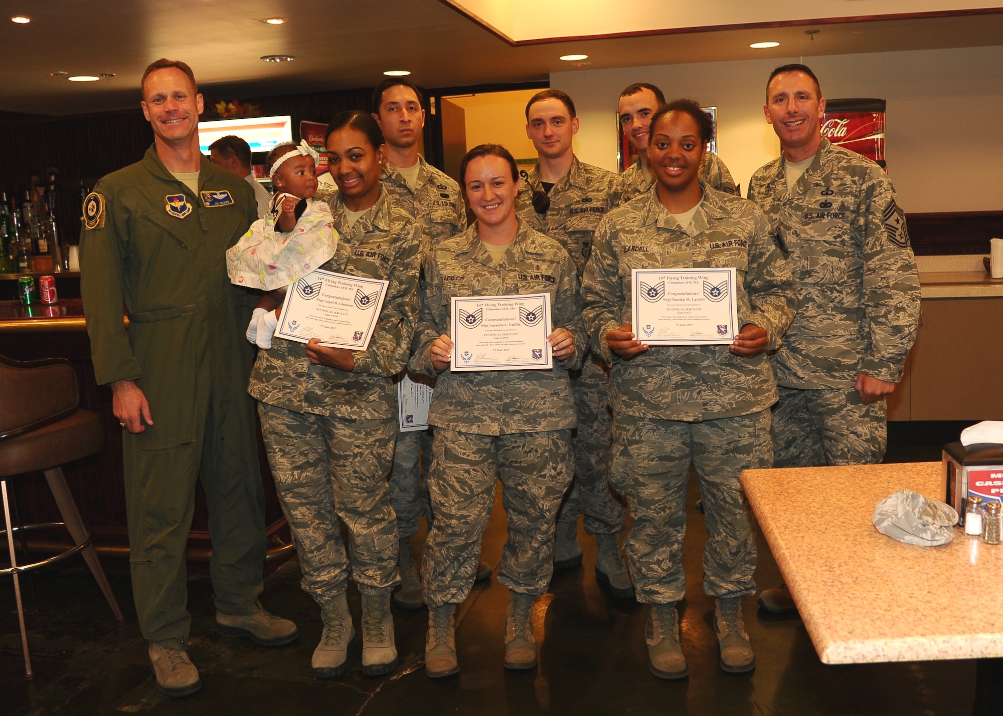 Col. Jim Sears, 14th Flying Training Wing Commander, and Chief Master Sgt. Vance Kondon,14th Flying Training Wing Command Chief, congratulate (left to right) Staff Sgt. Aapri Gholston, 14th Medical Support Squadron, Staff Sgt.  Roland Demoss, 14th Operations Support Squadron,  Staff Sgt. Amanda Padilla, 14th Flying Training Wing, Staff Sgt. Nathan Dooge, 14th Security Forces Squadron, Staff Sgt. Michael McElroy, 14th Operations Support Squadron, Staff Sgt. Tamika Lardell, 14th Medical Operations Squadron, at the Non Commissioned Officer promotion party June 27 at the Columbus Club. Not pictured but also selected for the rank of technical sergeant are: Staff Sgt. Jeri Catus, 14th Communications Squadron, Staff Sgt. Marcus Collins, 14th Security Forces Squadron, Staff Sgt. Timothy Martinez, Staff Sgt. Lucila Sanchez Martinez, 14th Flying Training Wing, and Staff Sgt. Demetrius Wofford. (U.S. Air Force Photo/ Airman 1st Class Stephanie Englar)