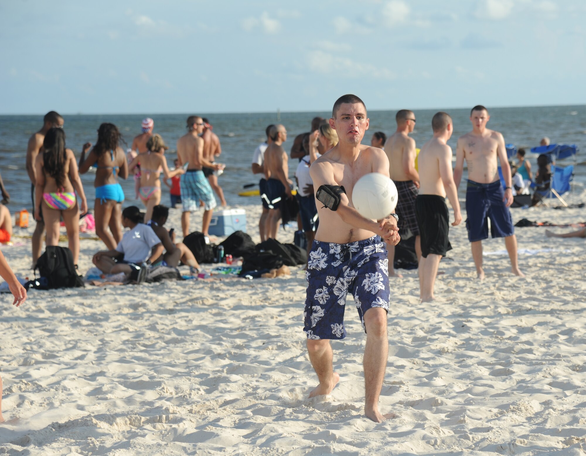 Airman 1st Class Justin May, 336th Training Squadron, serves a volleyball during Keesler’s 4th of July Beach Bash, July 4, 2013, on the Biloxi Beach.  The event, held in honor of our nation’s Independence Day, included food, games, music, contests and fireworks.  (U.S. Air Force photo by Kemberly Groue)