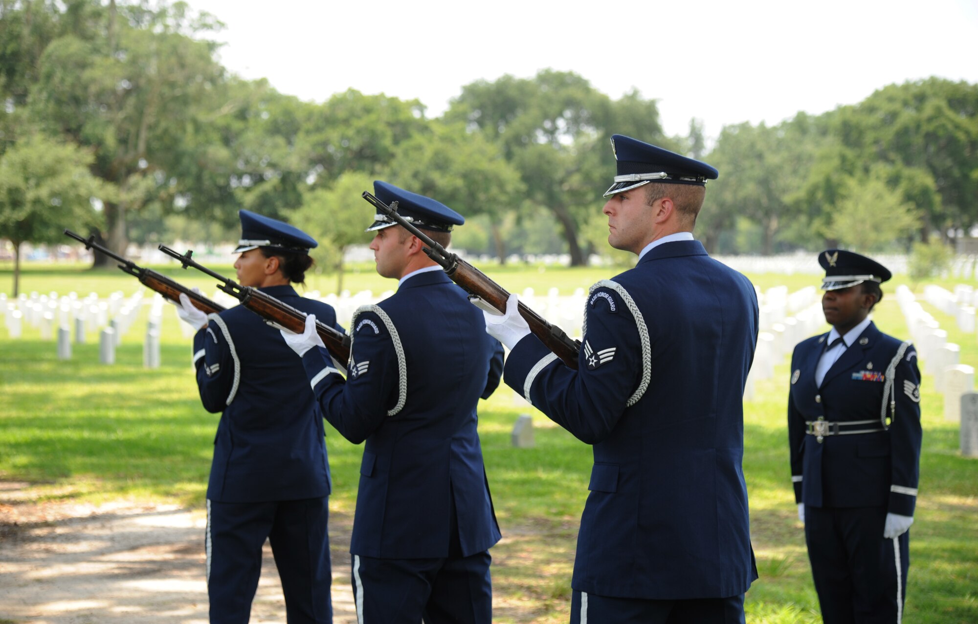 Airman 1st Class Kiara Daniels, Senior Airmen Gary McGiffin and David Rossi, and Staff Sgt. Giovanna Gladney, Keesler Honor Guard, rendered a three-volley salute during a funeral service July 2, 2013, at the Biloxi National Cemetery in Biloxi, Miss.  The Keesler Honor Guard’s primary mission is to render military honors for our nation’s fallen service members.  They also support other ceremonial functions such as saber/sword cordons, parades, posting of the colors at retirements, change of commands, prisoner of war/missing in action honors, weddings, sporting events and venues within the local community.  (U.S. Air Force photo by Kemberly Groue)