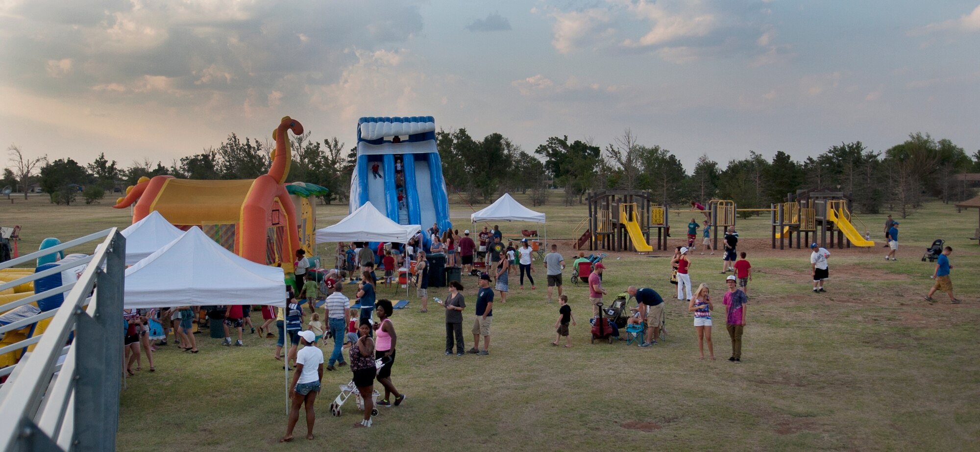 ALTUS AIR FORCE BASE, Okla. – Altus AFB Airmen and their families visit the inflatable play places during the 4th of July celebration at Excellence Park, July 4. More than 250 people attended the annual 4th of July event held by various base organizations. (U.S. Air Force photo by Senior Airman Dillon Davis/Released)