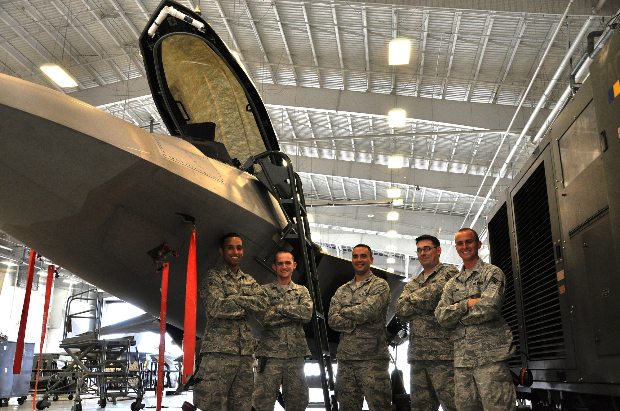 Capt. Stephen Rose, 43rd Aircraft Maintenance Unit officer in charge; Tech. Sgt. Kraig Callais, 43rd AMU avionics fleet health manager; Senior Airman Christopher Dunn, 43rd AMU F-22 specialist; Airman 1st Class Kenan Harvey, 43rd AMU F-22 specialist; and Airman 1st Class Daniel Ramize, 43rd AMU F-22 specialist, pose in front of an F-22 Raptor that they are currently working on inside the hangar of the 43rd AMU at Tyndall Air Force Base. The Avionics Health of the Fleet program was implemented to increase the number of fully mission capable F-22s on Tyndall’s flight line. (U.S. Air Force photo by Airman 1st Class Alex Echols)