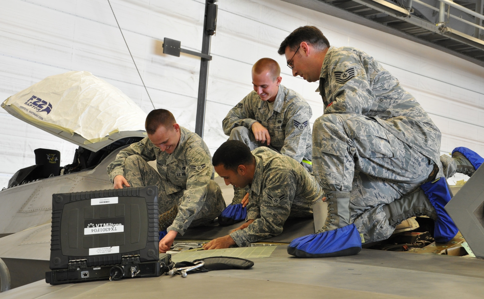 Tech. Sgt. Kraig Callais, 43rd Aircraft Maintenance Unit avionics fleet health manager, Senior Airman Christopher Dunn, 43rd AMU F-22 specialist, Airman 1st Class Kenan Harvey, 43rd AMU F-22 specialist and Airman 1st Class Daniel Ramize, 43rd AMU F-22 specialist, address an issue on top of an F-22 Raptor as part of the Avionics Health of the Fleet inside the hangar of the 43rd AMU at Tyndall Air Force Base, Fla. AVHOF is a program implemented to increase the number of fully mission capable F-22s on Tyndall’s flight line. (U.S. Air Force photo by Airman 1st Class Alex Echols)