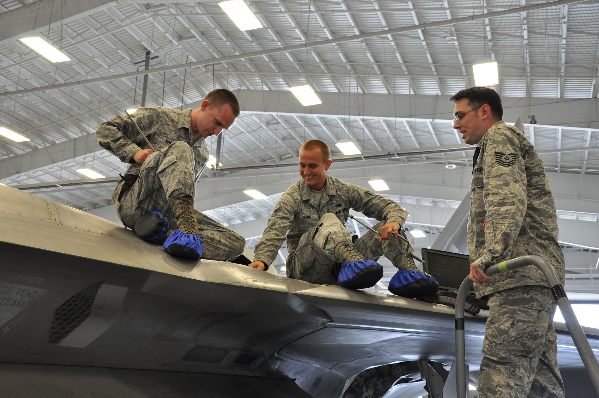 Tech. Sgt. Kraig Callais, 43rd Aircraft Maintenance Unit avionics fleet health manager; Senior Airman Christopher Dunn, 43rd AMU F-22 specialist; and Airman 1st Class Kenan Harvey, 43rd AMU F-22 specialist, address an issue of an F-22 Raptor as part of Avionics Health of the Fleet inside the hangar of the 43rd AMU at Tyndall Air Force Base, Fla. AVHOF is a program implemented to increase the number of fully mission capable F-22s on Tyndall’s flight line. (U.S. Air Force photo by Airman 1st Class Alex Echols)