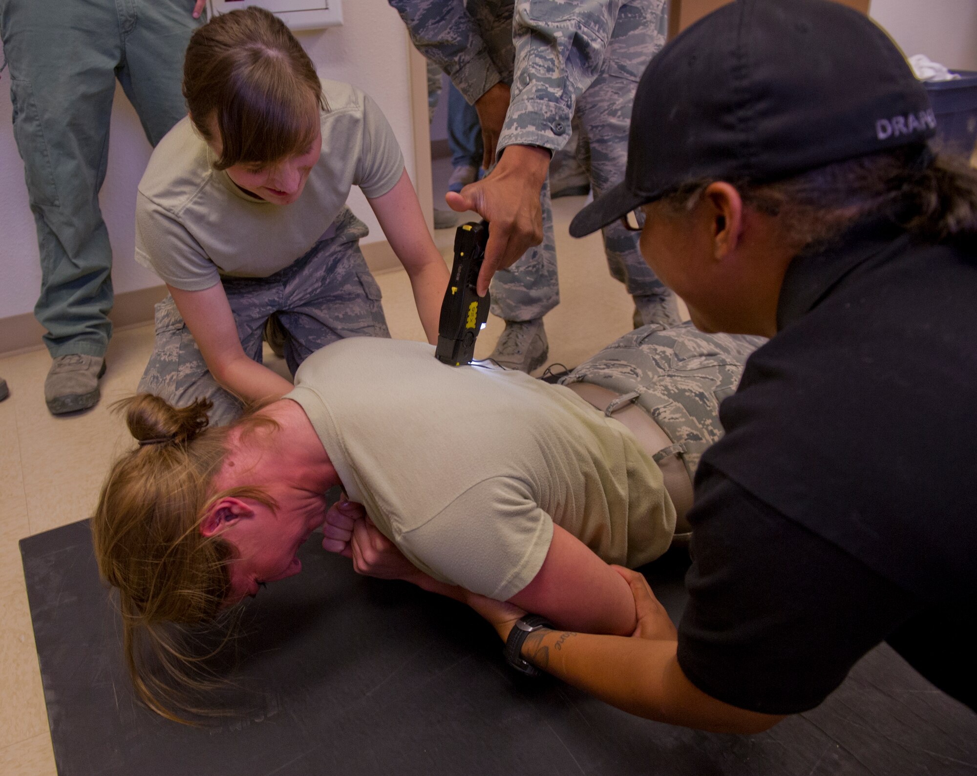 Britney Petrina, U.S. Air Force Academy cadet, receives a five second burst from a stun gun at the 49th Security Forces Squadron at Holloman Air Force Base, N.M., June 28. The 49th SFS gave the Cadets insight into their training requirements during the visit. The Air Force Academy Cadets spent two weeks at Holloman to gain insight on their career options after the academy. (U.S. Air Force photo by Airman 1st Class Aaron Montoya/Released)