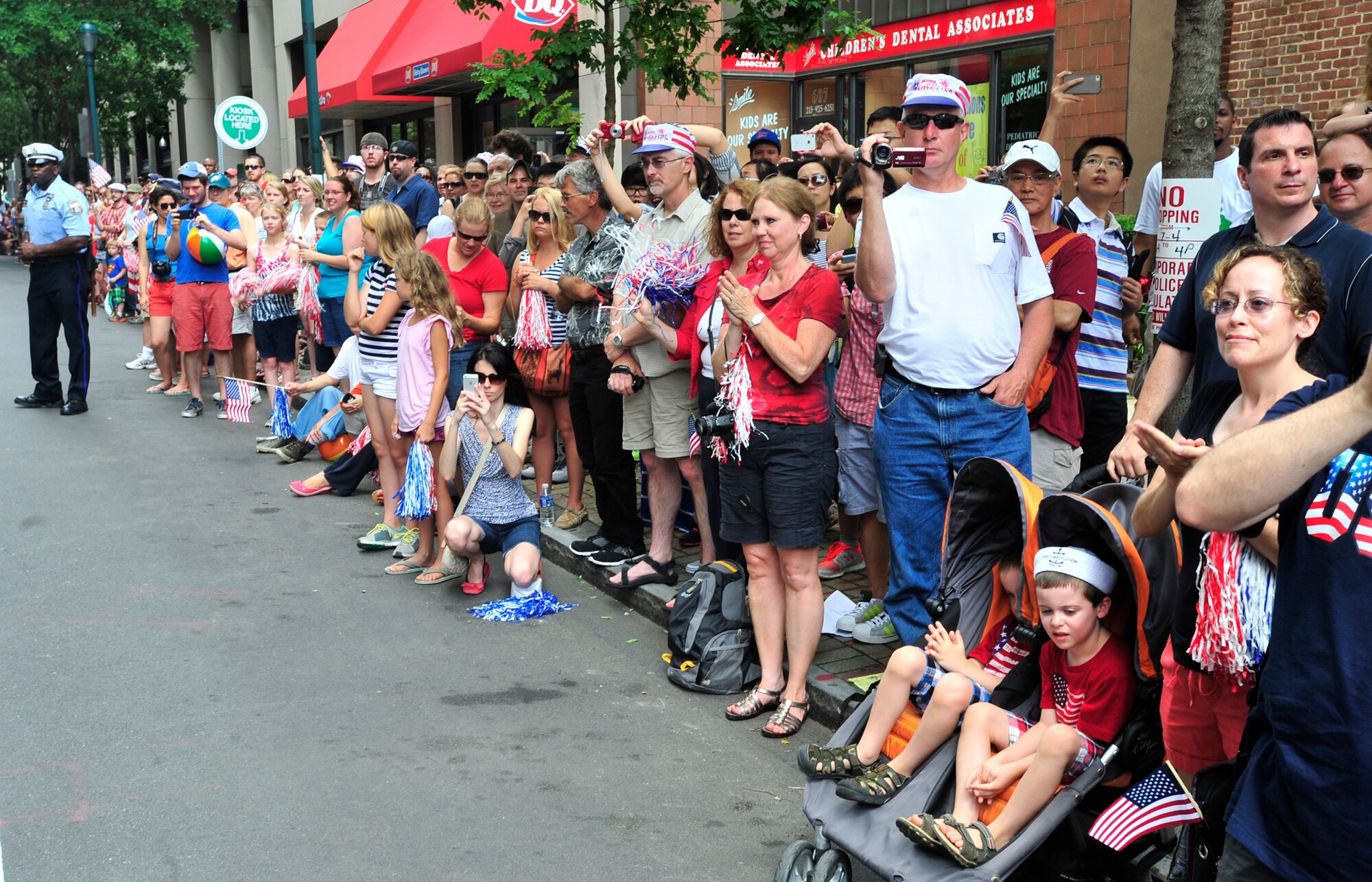 Spectators cheer and take photos as members of Team Dover march by during the WAWA Welcome America Independence Day Parade July 4, 2013, in Philadelphia, Pa. Units from all four branches of the armed services participated in the parade. (U.S. Air Force photo/Tech. Sgt. Chuck Walker)