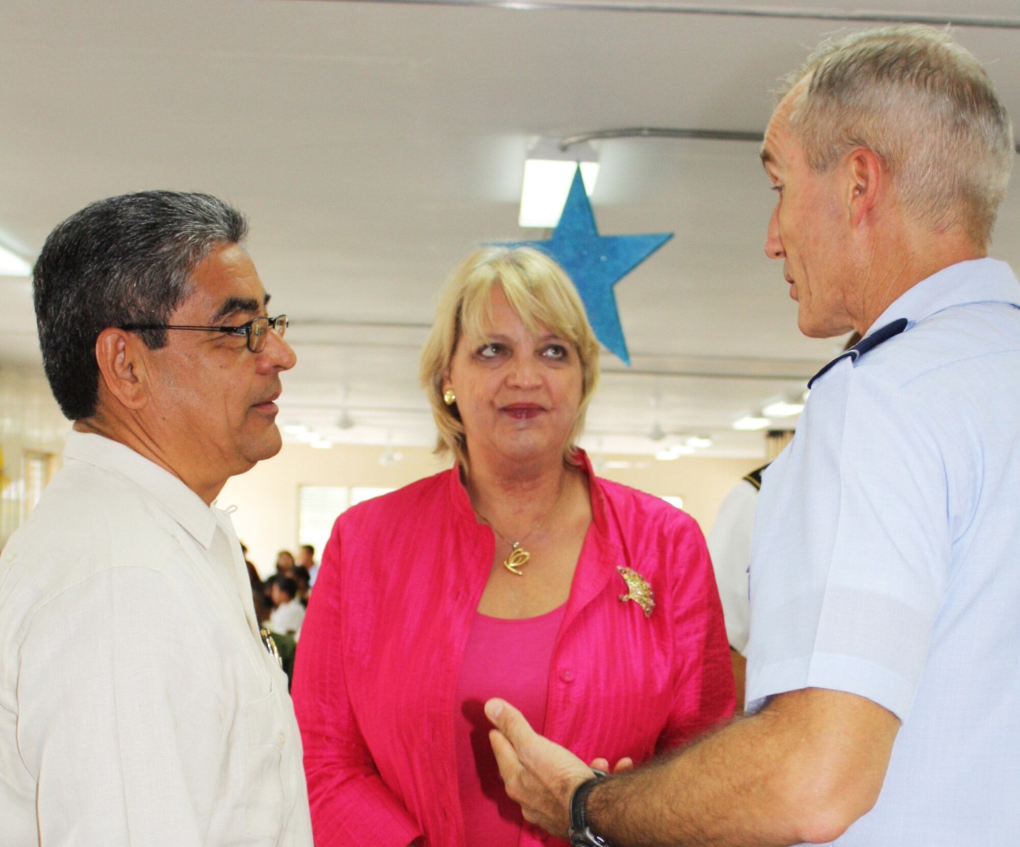 U.S. Air Force Col. Stuart Weinberger, right, Task Force Mahogany commander, speaks with Gaspar Vega, left, the deputy prime minister of Belize, and Margaret Hawthorne, the U.S. Embassy’s chargé d’affaires, during the closing ceremonies of New Horizons at Trial Farm Government School June 28, 2013. New Horizons is a training exercise led by U.S. Southern Command that provided medical treatment as well as constructed several classrooms throughout Belize. (Courtesy photo)