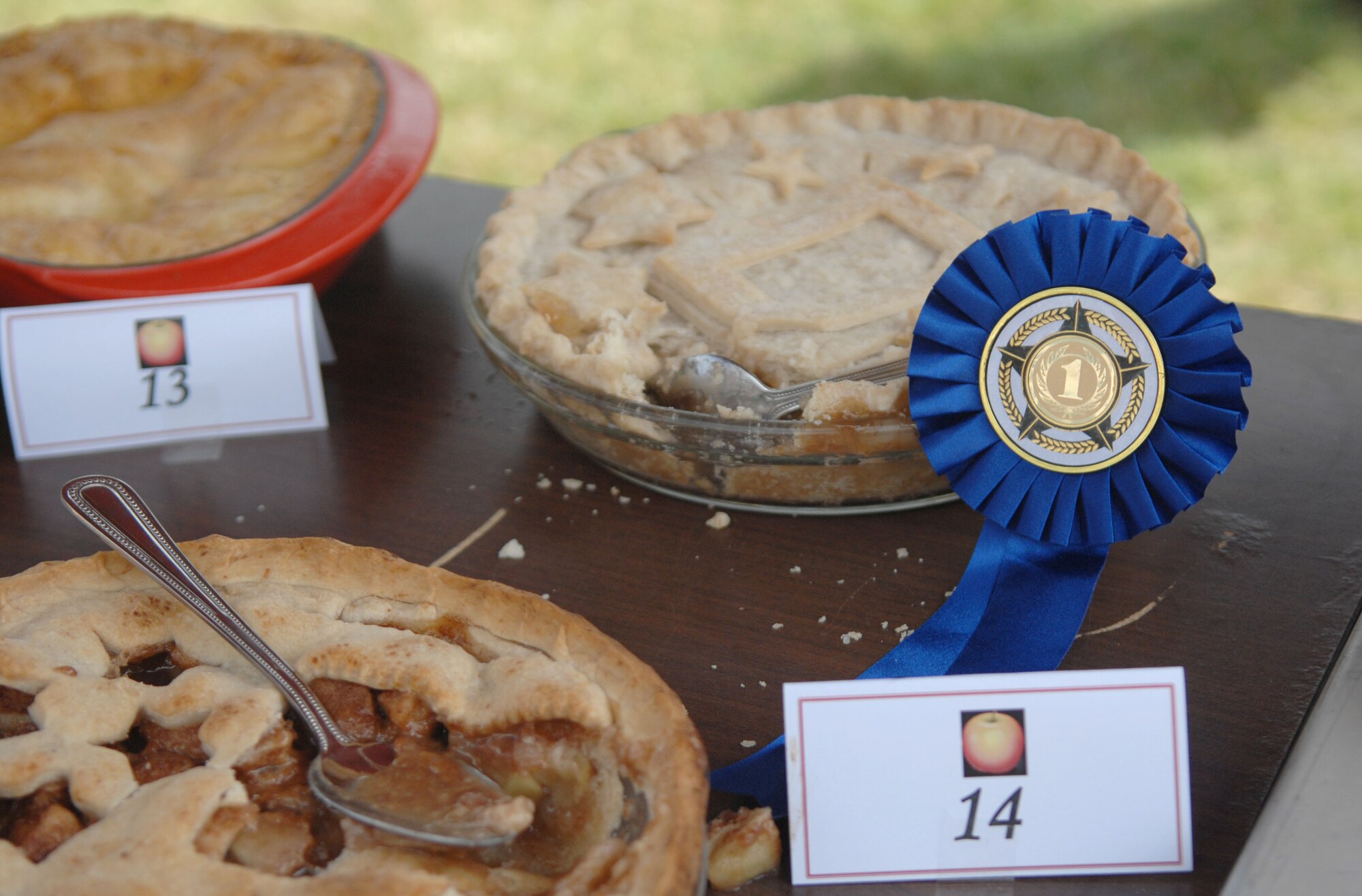 The “Square D” pie, baked by Lt. Col. April Dwyer, 100th Force Support Squadron commander, earns a first-place ribbon after an apple pie contest July 3, 2013, during the Independence Day celebration on RAF Mildenhall, England. Team Mildenhall leadership judged the pies and picked their top three favorites. The contest, an American tradition, offers a way for Airmen overseas to feel more at home. (U.S. Air Force photo by Airman 1st Class Dillon Johnston/Released)