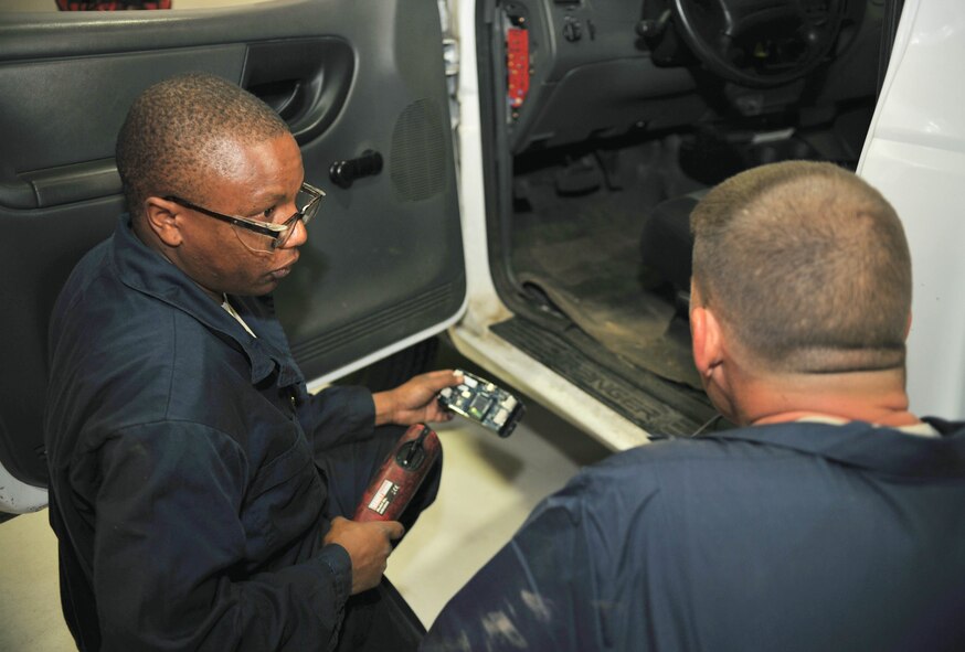 Staff Sgt. Peter Mwangi, 100th Logistics Readiness Squadron vehicle and vehicular equipment maintainer from Las Vegas, explains the features and purpose of an automotive information module 2 system to Chief Master Sgt. Tracy Jones, 100th Air Refueling Wing command chief, July 8, 2013, on RAF Mildenhall, England. The AIM2 system will be installed in all government-owned general purpose vehicles and is used to increase fuel efficiency and vehicle security. (U.S. Air Force photo by Staff Sgt. Jerilyn Quintanilla/Released)
