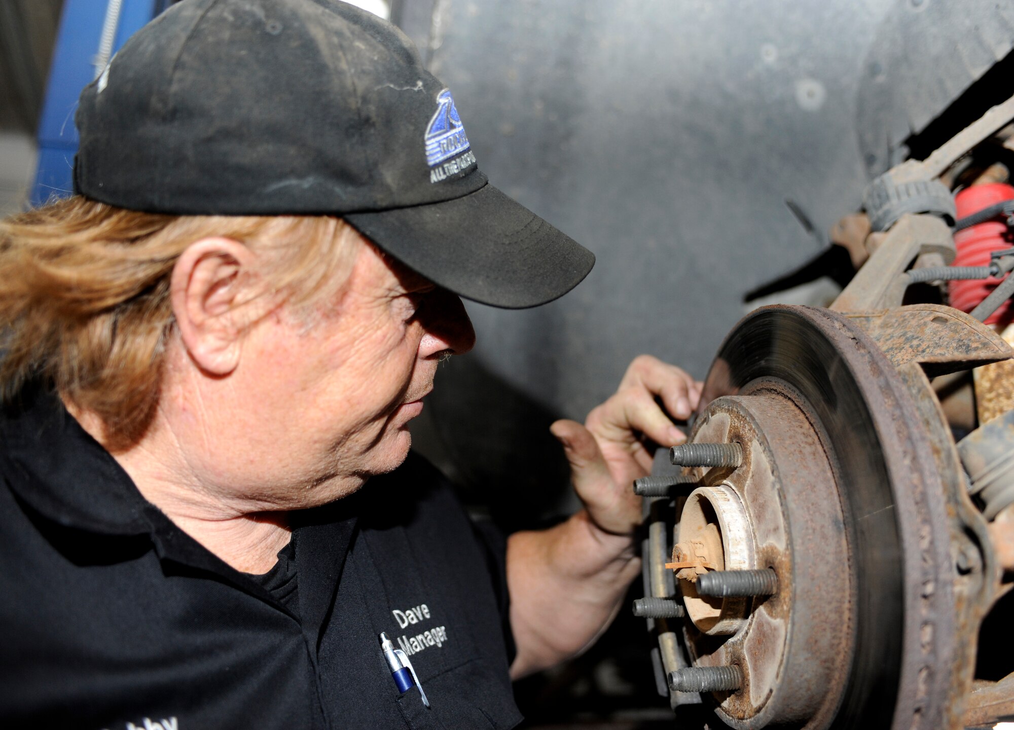 Dave Roney, 28th Force Support Squadron Auto Hobby Center manager, inspects a front brake on a vehicle at the Auto Hobby Center on Ellsworth Air Force Base, S.D., July 2, 2013. Drivers are encouraged to have their vehicles inspected prior to a long trip to ensure the tires and brakes are in good condition and that antifreeze and engine oil levels are within safe operating guidelines. (U.S. Air Force photo by Airman 1st Class Ashley J. Thum/Released)