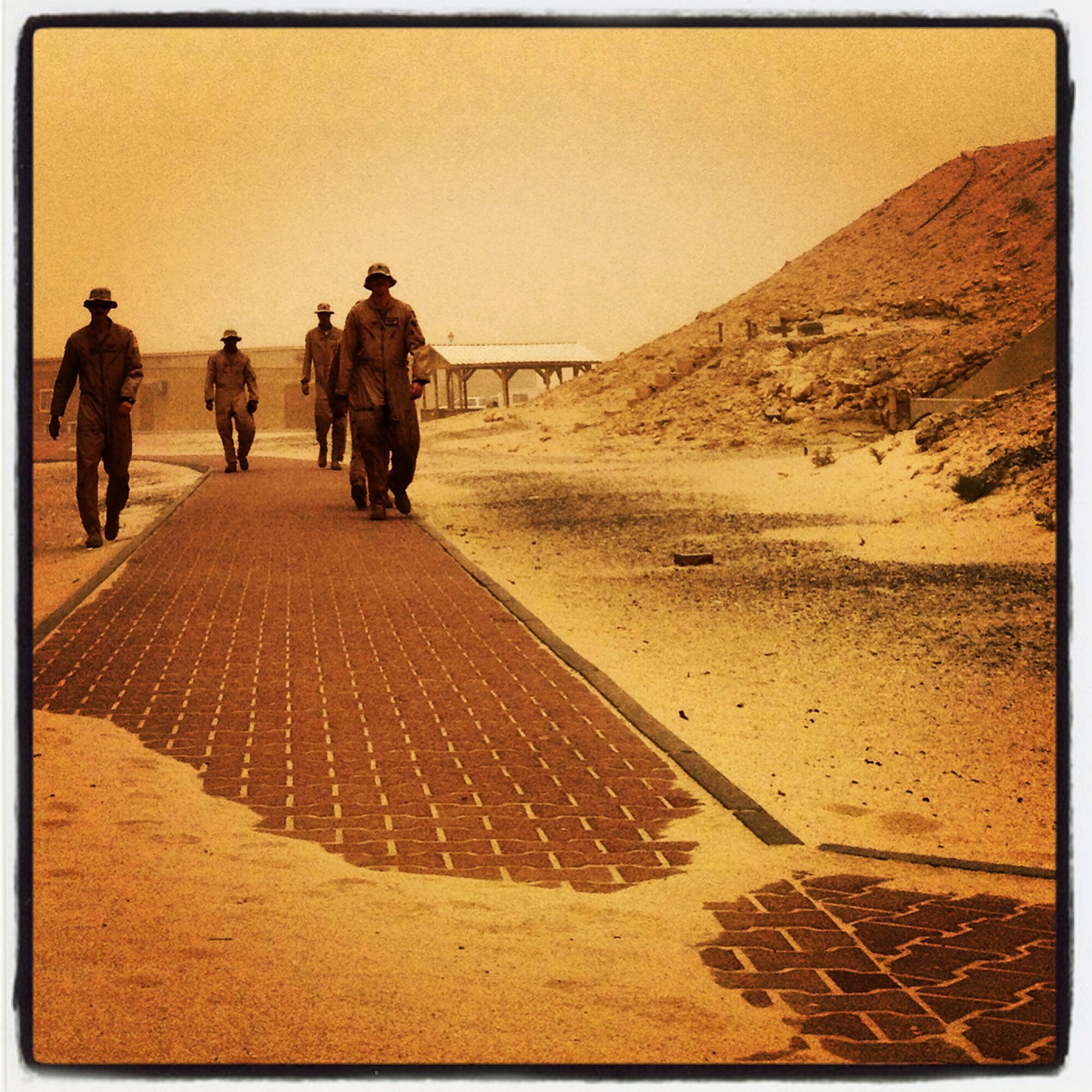 Airmen make their way through the wind and sand at an undisclosed base in Southwest Asia, Monday, July 8, 2013.  (U.S. Air Force photo by 1st Lt. Nathan Wallin) (This image was created using Instagram)