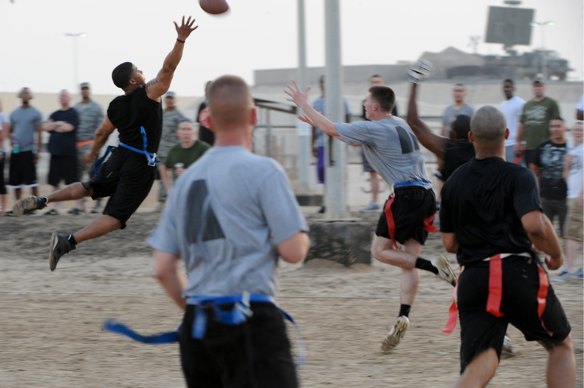 Dante Lewis, cornerback for the 380th Air Expeditionary Wing flag football team, reaches to block a pass during the Army vs. Air Force game at an undisclosed location in Southwest Asia. The game went into overtime with Army edging out the Air Force by a touchdown with a final score of 25-19. Lewis is deployed from Joint Base Langley-Eustis, Va. (U.S. Air Force photo by Staff Sgt. Joshua J. Garcia)

  