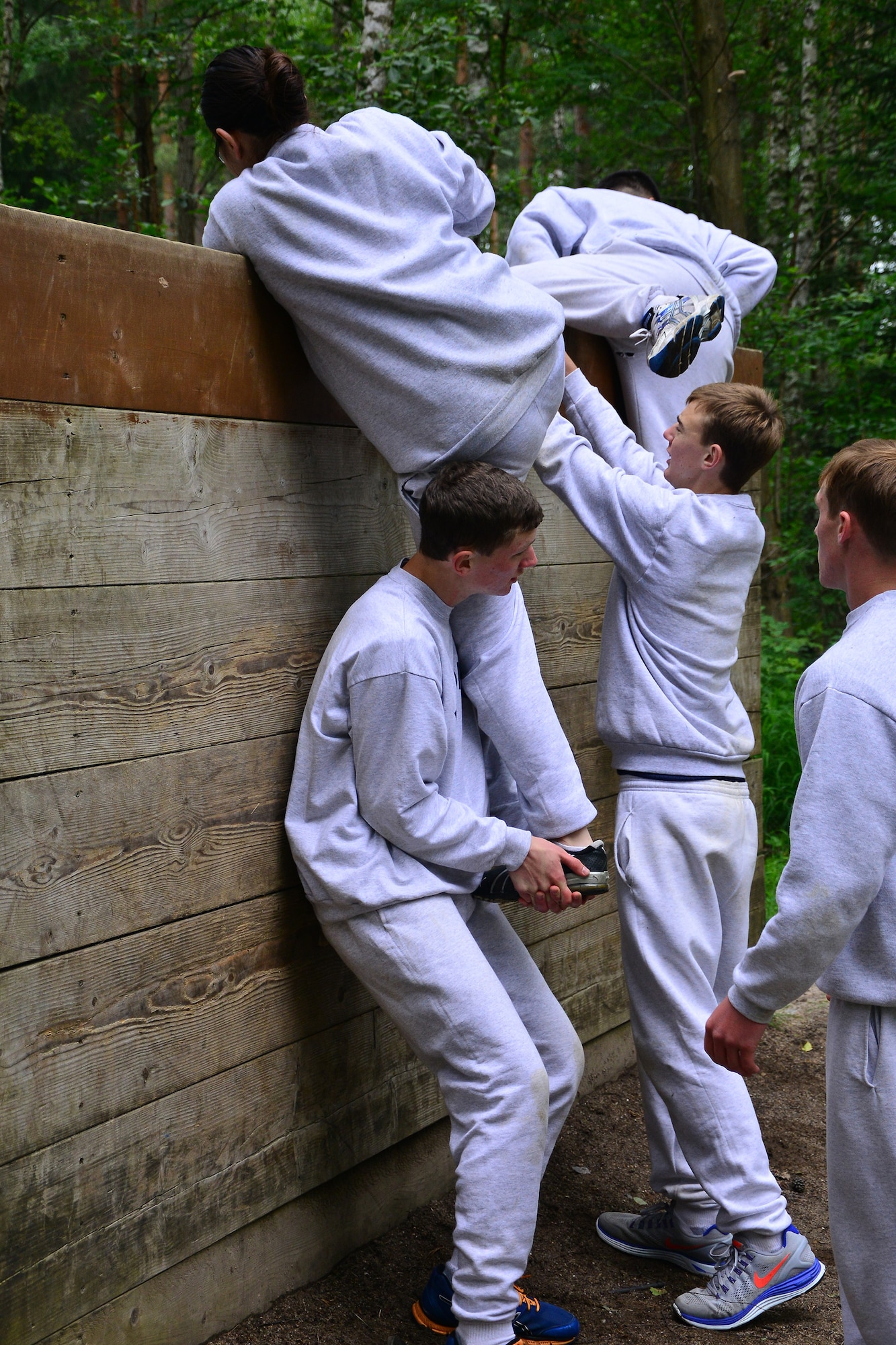 Air Force Junior Reserve Officers’ Training Corps cadets work together to get a teammate over an obstacle at a military confidence course June 26, 2013, Grafenwoehr, Germany. Sixty-six high school students from around Europe attended the Air Force Junior Reserve Officers’ Training Corps summer program June 23-29. According to its website, the JROTC objectives are to educate and train high school cadets in citizenship, promote community service, instill responsibility, character, and self-discipline, and provide instruction in air and space fundamentals. (U.S. Air Force photo/Tech. Sgt. Chad Thompson)