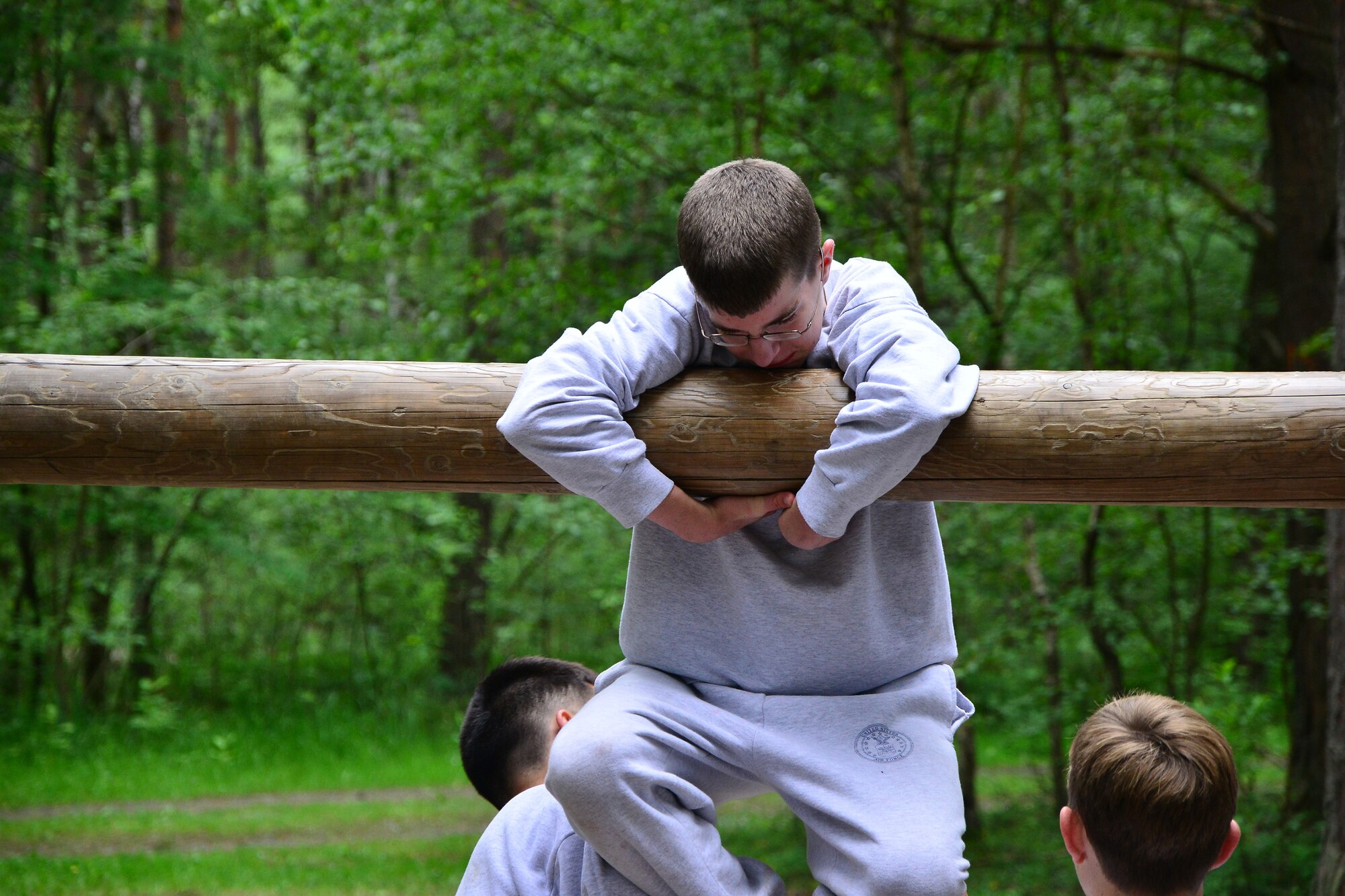 Air Force Junior Reserve Officers’ Training Corps cadets work together to get a teammate over the “Belly Buster” obstacle at a military confidence course June 26, 2013, Grafenwoehr, Germany. Sixty-six high school students from around Europe attended the Air Force Junior Reserve Officers’ Training Corps summer program June 23-29. According to its website, the JROTC objectives are to educate and train high school cadets in citizenship, promote community service, instill responsibility, character, and self-discipline, and provide instruction in air and space fundamentals. (U.S. Air Force photo/Tech. Sgt. Chad Thompson)
