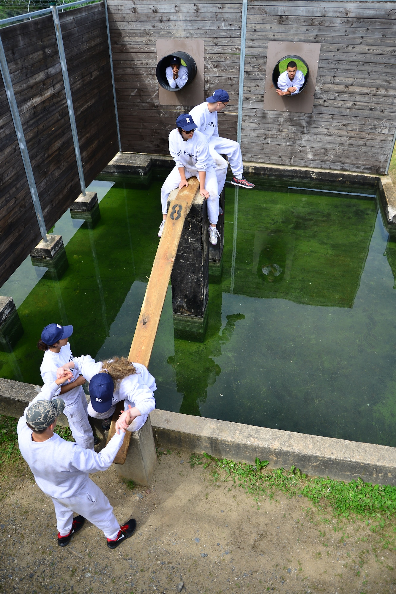 A group of Air Force Junior Reserve Officers’ Training Corps cadets negotiate an obstacle at the leadership reaction course June 24, 2013, Grafenwoehr, Germany. The leadership reaction course gave the students an opportunity to test their teamwork and leadership ability. According to its website, the JROTC objectives are to educate and train high school cadets in citizenship, promote community service, instill responsibility, character, and self-discipline, and provide instruction in air and space fundamentals. (U.S. Air Force photo/Tech. Sgt. Chad Thompson)