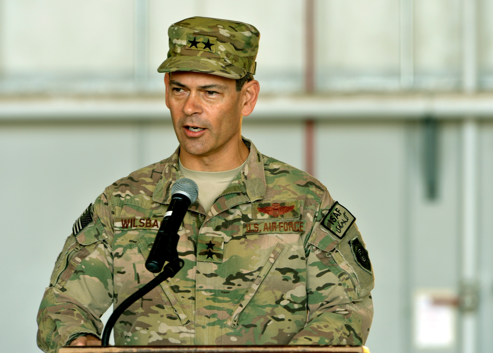 Maj. Gen. Kenneth S. Wilsbach, commander, 9th Air and Space Expeditionary Task Force – Afghanistan and deputy chief of staff Air, International Security Assistance Force Joint Command, addresses 455th Air Expeditionary Wing service members during a change of command ceremony at Bagram Airfield, Afghanistan, July 8. (U.S. Air Force photo/Staff Sgt. Stephenie Wade)