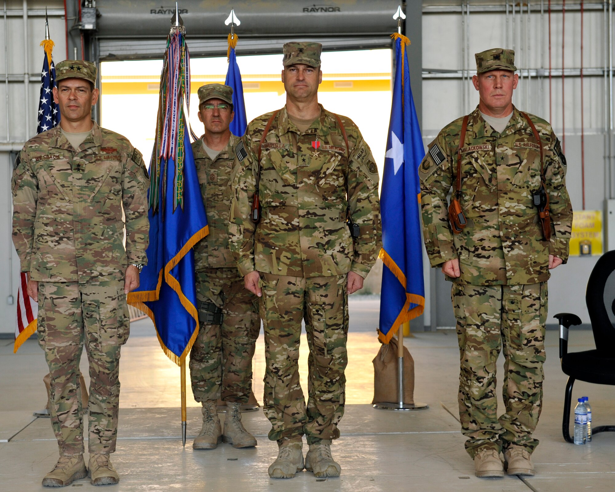 Maj. Gen. Kenneth S. Wilsbach, commander, 9th Air and Space Expeditionary Task Force – Afghanistan and deputy chief of staff Air, International Security Assistance Force Joint Command, Chief Master Sgt. Steve Bohannon, command chief master sergeant of the 455th Air Expeditionary Wing, Brig. Gen. Joseph T. Guastella, outgoing 455th commander and Brig. Gen. Patrick C. Malackowski, 455th AEW commander prepare for the change of command ceremony held at Bagram Airfield, Afghanistan, July 8. (U.S. Air Force photo/Staff Sgt. Stephenie Wade)