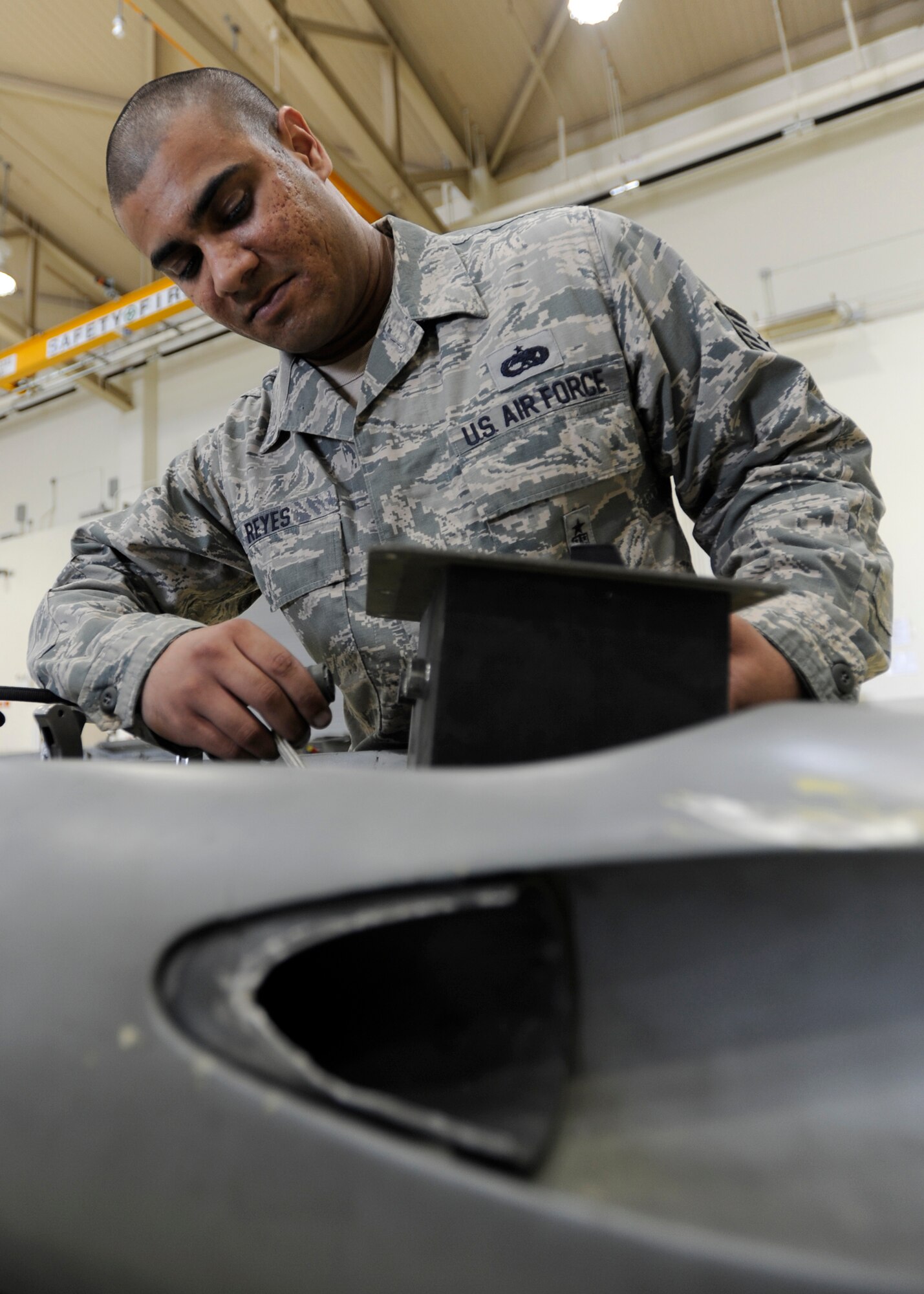 KUNSAN AIR BASE, Republic of Korea -- Staff Sgt. Joshua Reyes, 8th Maintenance Squadron armament flight maintenance floor supervisor, installs weapons inspection equipment into a SUU-20 rocket launcher, at Kunsan Air Base, Republic of Korea, June 24, 2013. Reyes was named Kunsan’s “Pride of the Pack” winner June 3 to 9, 2013. (U.S. Air Force photo by Staff Sgt. Tong Duong/ Released)