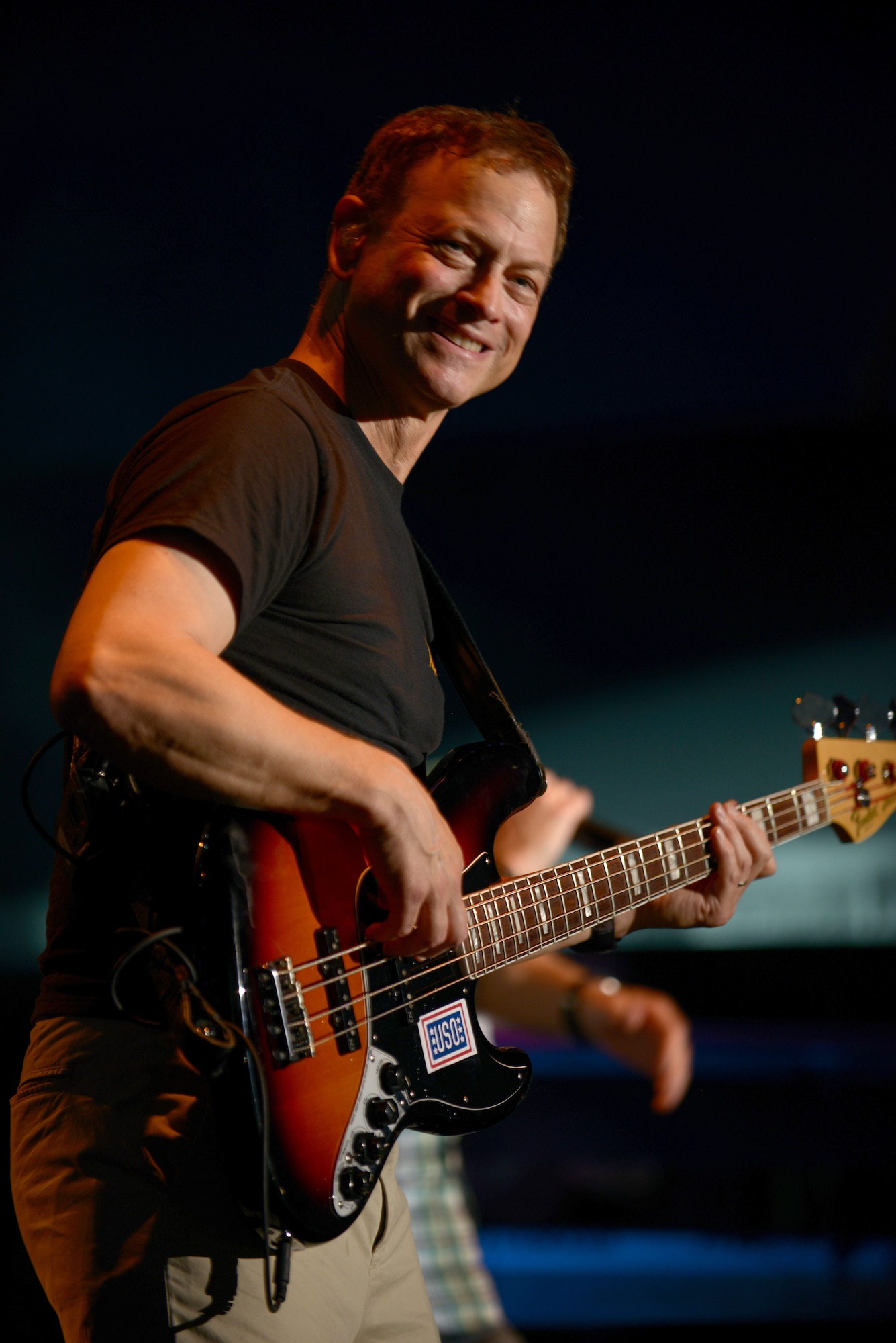 Gary Sinise, actor and bass player for the Lt. Dan Band, performs for military members and their families at U.S. Marine Corps Air Station Futenma, Japan, July 6, 2013. This was the last show on their USO tour of Pacific bases. Sinise is also the founder of the Gary Sinise Foundation, an organization dedicated to providing assistance to those who serve in their time of need. (U.S. Air Force photo by Tech. Sgt. Jocelyn Rich-Pendracki/Released)