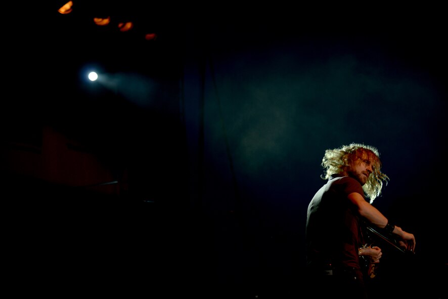 Dan Myers, vocalist and violinist for the Lt. Dan Band, performs for military members and their families at U.S. Marine Corps Air Station Futenma, Japan, July 6, 2013. The performance was the band's final show in their Pacific USO tour. (U.S. Air Force photo by Tech. Sgt. Jocelyn Rich-Pendracki/Released)