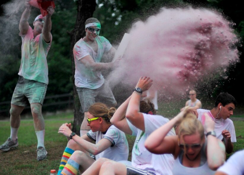 Two participants in the Freedom Fusion Fun Run throw colored corn starch on unsuspecting participants at Osan Air Base, Republic of Korea, July 4, 2013. The Freedom Fusion Fun Run was based on the color run, a unique paint race that emphasizes fun over competition. (U.S. Air Force photo/Senior Airman Siuta B. Ika)