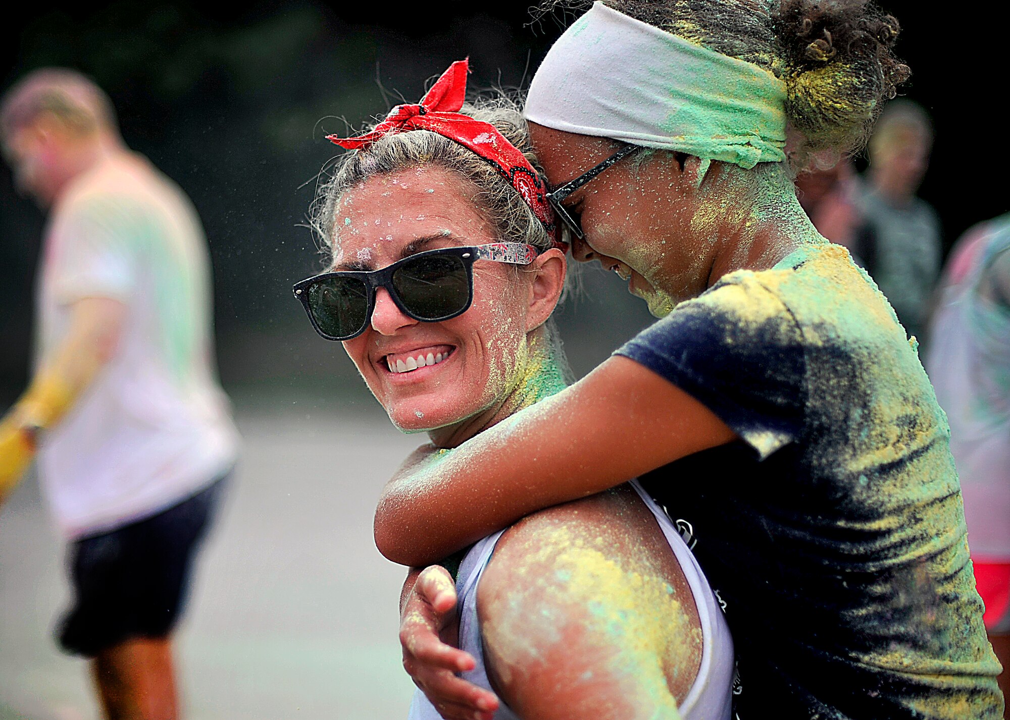 Beth and Kaiya,13, Erkkila, wife and daughter of Maj. Richard Erkkila, 25th Fighter Squadron director of operations, share a laugh during the Freedom Fusion Fun Run at Osan Air Base, Republic of Korea, July 4, 2013. The Erkkila’s were two of more than 350 people that participated in the colored fun run, which was the first of its kind held on the ROK. (U.S. Air Force photo/Senior Airman Siuta B. Ika)